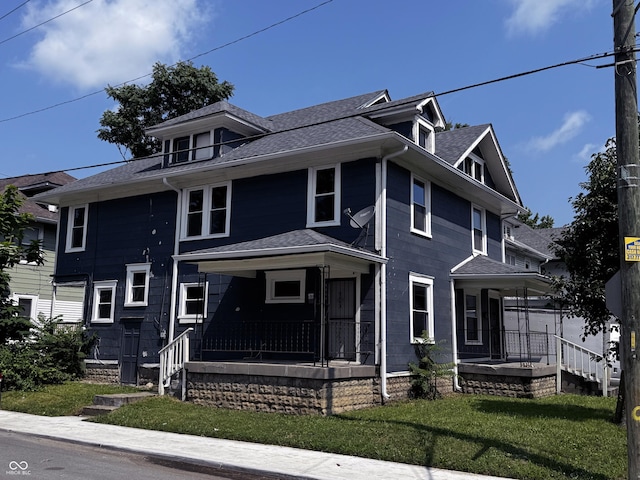 3502 N Kenwood Ave, Indianapolis, IN 46208 - american foursquare style home with a porch, a front yard, and roof with shingles
