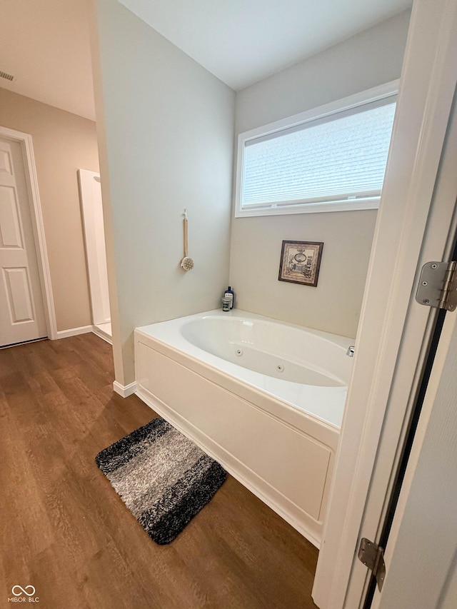 9903 Deep Royal Way, Indianapolis, IN 46239 - bathroom with wood finished floors, a whirlpool tub, and baseboards