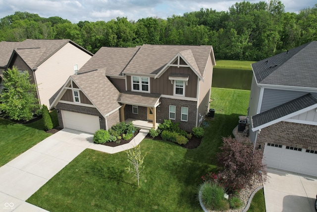 9903 Deep Royal Way, Indianapolis, IN 46239 - craftsman house featuring board and batten siding, brick siding, driveway, a front yard, and roof with shingles