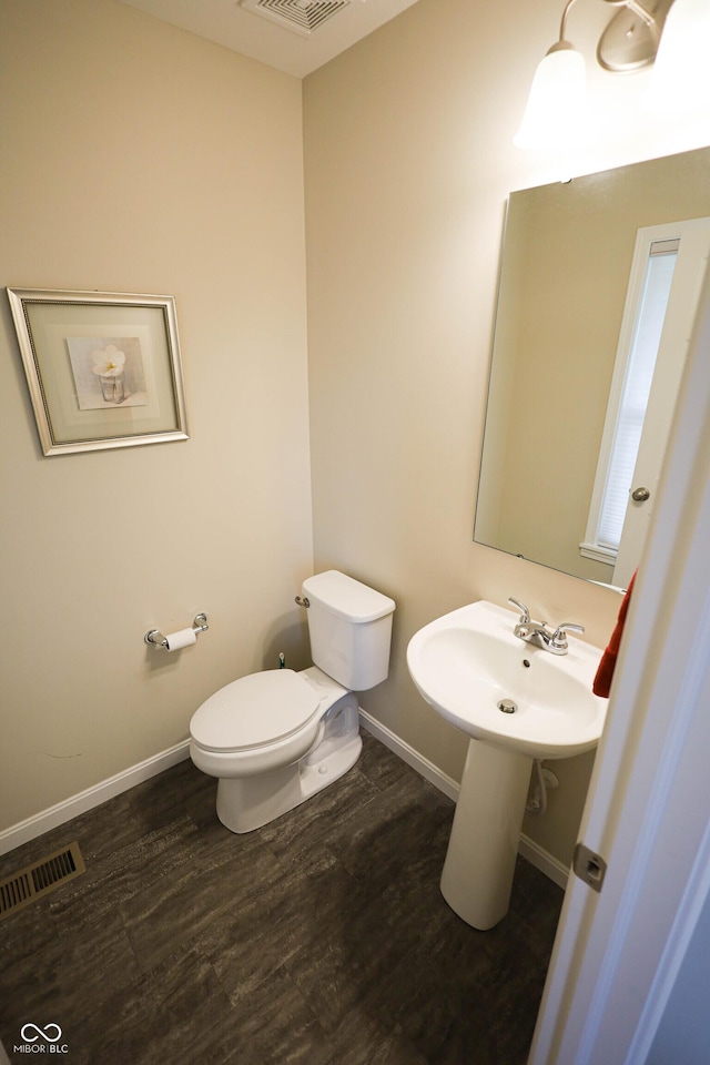 9903 Deep Royal Way, Indianapolis, IN 46239 - bathroom featuring toilet, wood finished floors, and baseboards