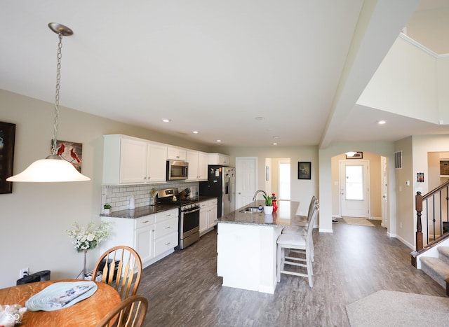 9903 Deep Royal Way, Indianapolis, IN 46239 - kitchen with appliances with stainless steel finishes, a sink, dark wood-style flooring, a center island with sink, and white cabinets