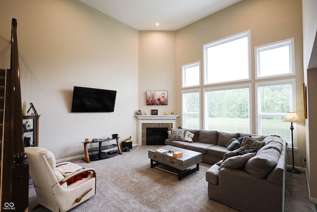 9903 Deep Royal Way, Indianapolis, IN 46239 - living area with carpet floors, a fireplace, a high ceiling, and baseboards