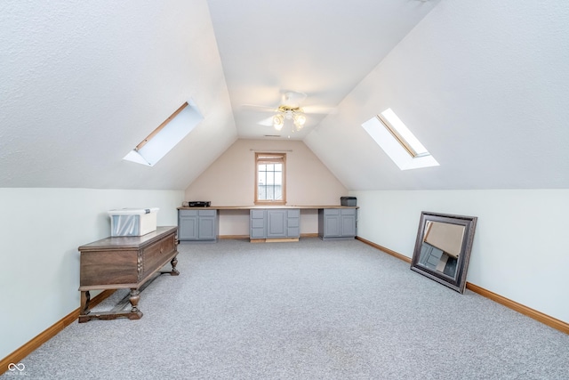 4399 Summerhaven Dr, New Palestine, IN 46163 - additional living space featuring a skylight, a ceiling fan, carpet, baseboards, and lofted ceiling