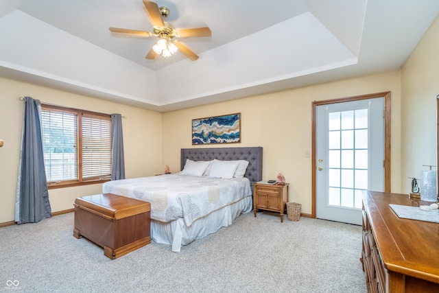 4399 Summerhaven Dr, New Palestine, IN 46163 - bedroom featuring a raised ceiling, carpet, multiple windows, and a ceiling fan