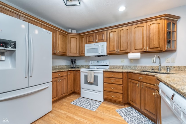 4399 Summerhaven Dr, New Palestine, IN 46163 - kitchen featuring white appliances, a sink, brown cabinetry, light wood-type flooring, and recessed lighting