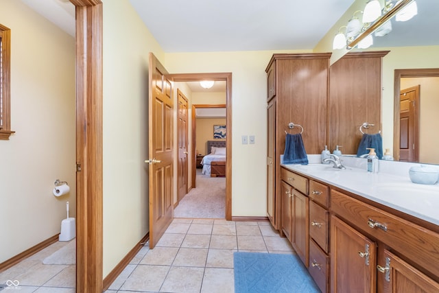 4399 Summerhaven Dr, New Palestine, IN 46163 - ensuite bathroom with double vanity, tile patterned floors, and baseboards