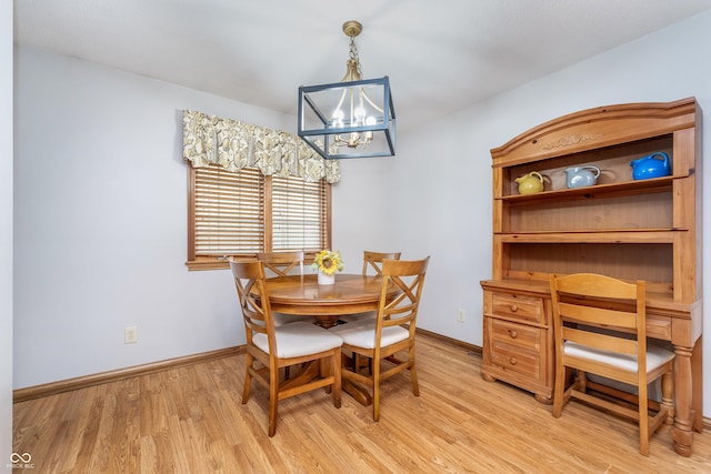 4399 Summerhaven Dr, New Palestine, IN 46163 - dining area featuring light wood-style floors, baseboards, and a chandelier
