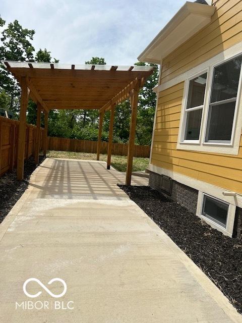 2936 Guilford Ave, Indianapolis, IN 46205 - fenced backyard with a pergola, a patio area, and driveway