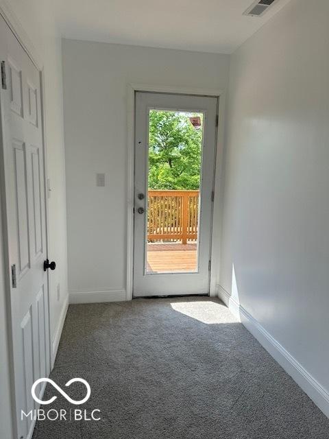 2936 Guilford Ave, Indianapolis, IN 46205 - doorway to outside featuring carpet flooring and baseboards