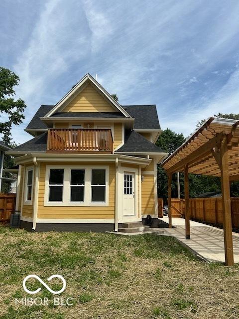 2936 Guilford Ave, Indianapolis, IN 46205 - back of property with a balcony, a pergola, and a patio area