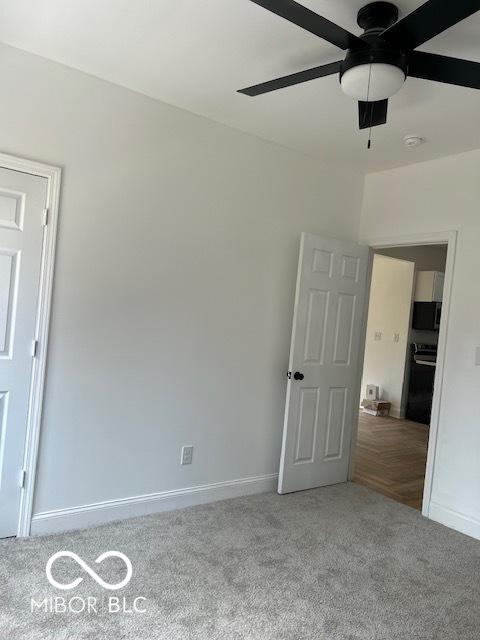 2936 Guilford Ave, Indianapolis, IN 46205 - unfurnished bedroom featuring carpet floors, baseboards, and a ceiling fan