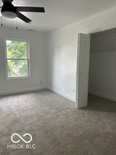 2936 Guilford Ave, Indianapolis, IN 46205 - unfurnished bedroom with carpet floors, baseboards, and ceiling fan