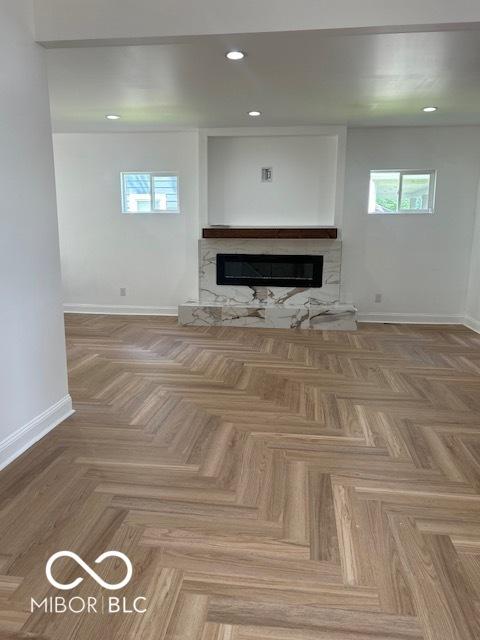 2936 Guilford Ave, Indianapolis, IN 46205 - unfurnished living room with healthy amount of natural light, baseboards, a fireplace, and recessed lighting
