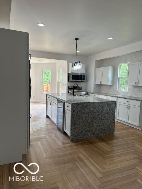 2936 Guilford Ave, Indianapolis, IN 46205 - kitchen with stainless steel microwave, freestanding refrigerator, recessed lighting, beverage cooler, and healthy amount of natural light