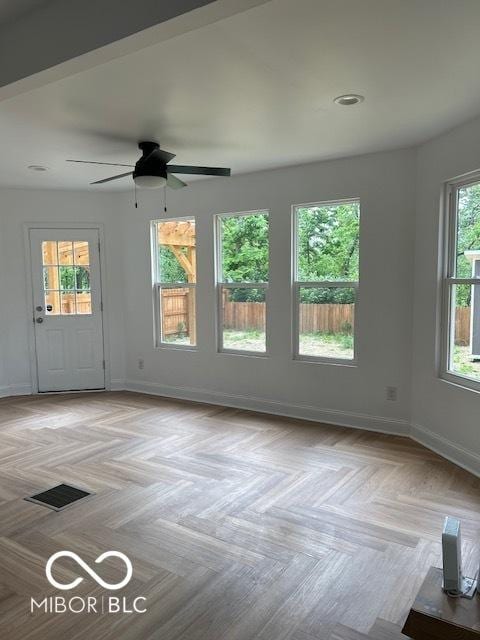 2936 Guilford Ave, Indianapolis, IN 46205 - unfurnished living room featuring baseboards and ceiling fan
