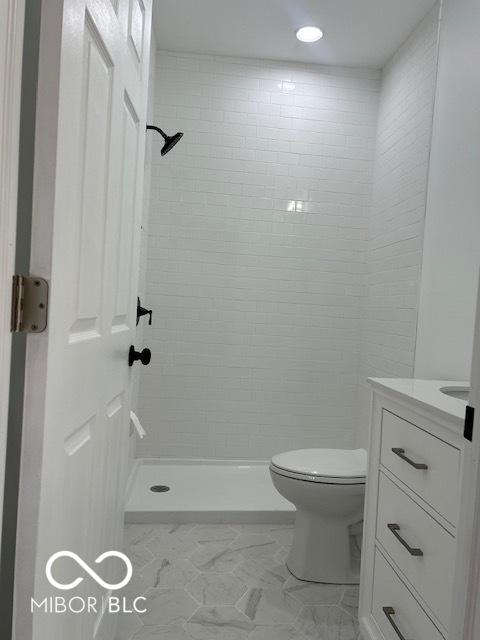 2936 Guilford Ave, Indianapolis, IN 46205 - bathroom with vanity, toilet, a stall shower, and marble finish flooring