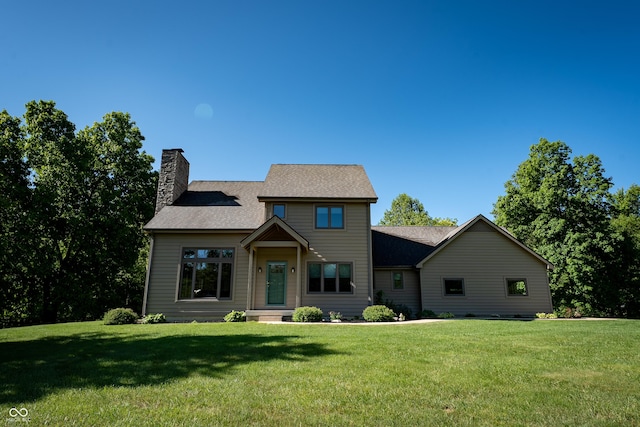 11875 W 700 S, Columbus, IN 47201 - view of front of house with a chimney, a front lawn, and roof with shingles