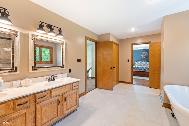 11875 W 700 S, Columbus, IN 47201 - ensuite bathroom featuring a soaking tub, double vanity, and baseboards