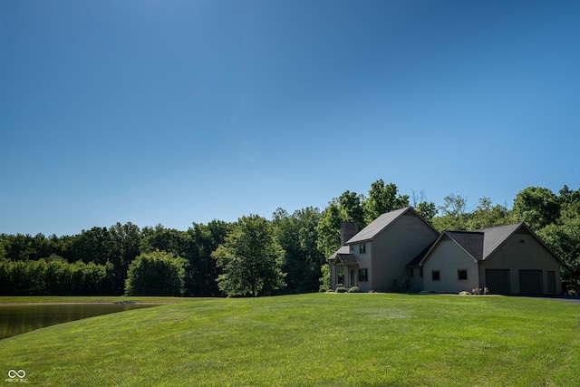 11875 W 700 S, Columbus, IN 47201 - view of green lawn with a garage and driveway