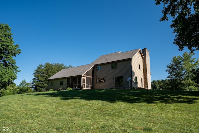 11875 W 700 S, Columbus, IN 47201 - rear view of property with a chimney, a lawn, and a sunroom