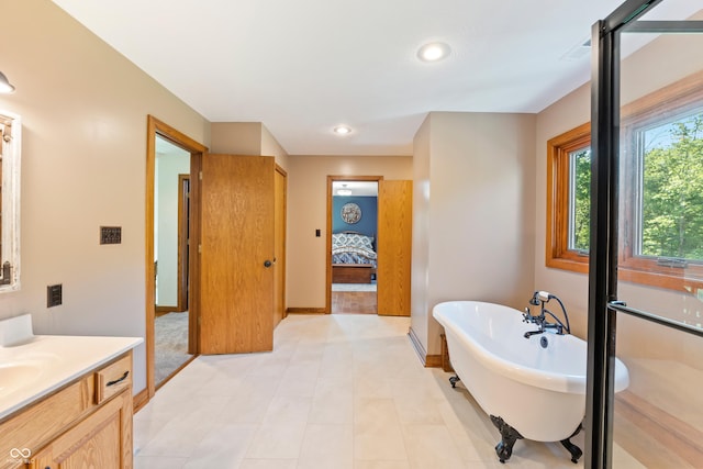 11875 W 700 S, Columbus, IN 47201 - ensuite bathroom featuring a freestanding tub, vanity, baseboards, and recessed lighting