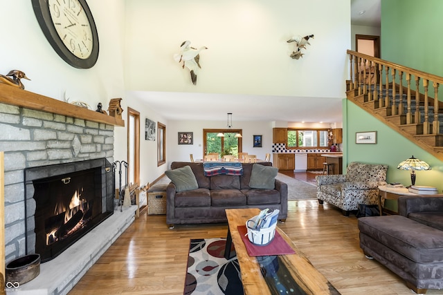 11875 W 700 S, Columbus, IN 47201 - living area featuring a towering ceiling, wood finished floors, a brick fireplace, and stairway