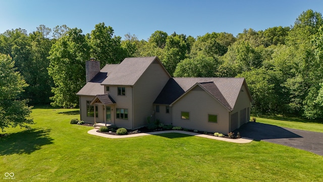 11875 W 700 S, Columbus, IN 47201 - view of front of property with a garage, a chimney, a front yard, and a forest view