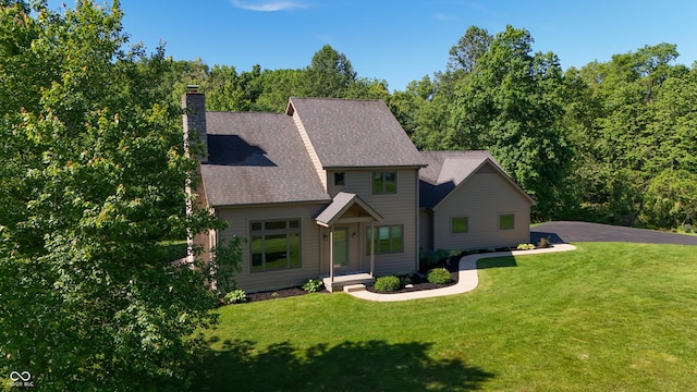 11875 W 700 S, Columbus, IN 47201 - view of front of house featuring a front lawn, a chimney, and roof with shingles