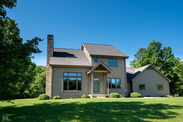 11875 W 700 S, Columbus, IN 47201 - view of front facade featuring a chimney, a front yard, and a shingled roof