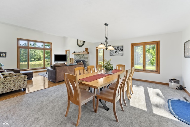 11875 W 700 S, Columbus, IN 47201 - dining space featuring light carpet, plenty of natural light, a fireplace, and baseboards