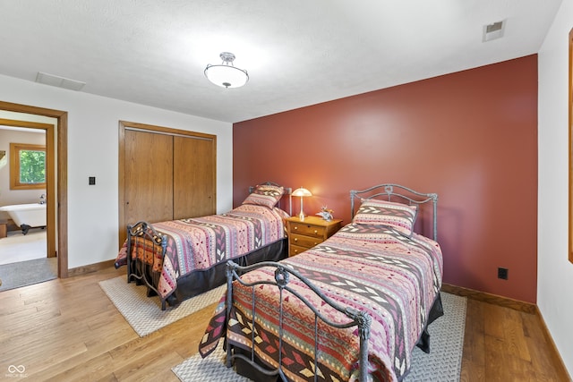 11875 W 700 S, Columbus, IN 47201 - bedroom featuring wood finished floors, a closet, and baseboards