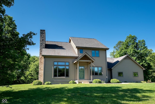 11875 W 700 S, Columbus, IN 47201 - view of front of home with a chimney, a front yard, and roof with shingles