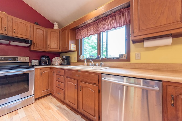 5821 Bittersweet Rd, Morgantown, IN 46160 - kitchen featuring appliances with stainless steel finishes, under cabinet range hood, a sink, vaulted ceiling, and light countertops