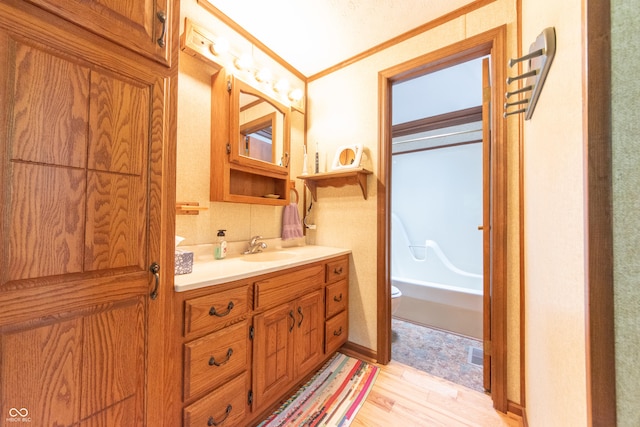 5821 Bittersweet Rd, Morgantown, IN 46160 - full bathroom featuring vanity, toilet, crown molding, wood finished floors, and shower / bath combination