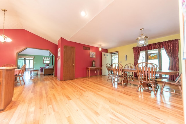 5821 Bittersweet Rd, Morgantown, IN 46160 - dining area with wood finished floors, a chandelier, vaulted ceiling, and arched walkways