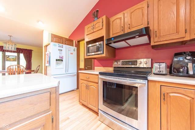 5821 Bittersweet Rd, Morgantown, IN 46160 - kitchen featuring appliances with stainless steel finishes, under cabinet range hood, vaulted ceiling, light countertops, and light wood-type flooring