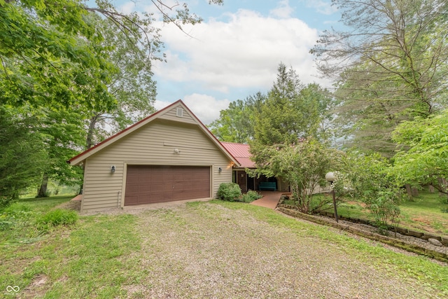 5821 Bittersweet Rd, Morgantown, IN 46160 - view of front of home with dirt driveway, metal roof, and an attached garage