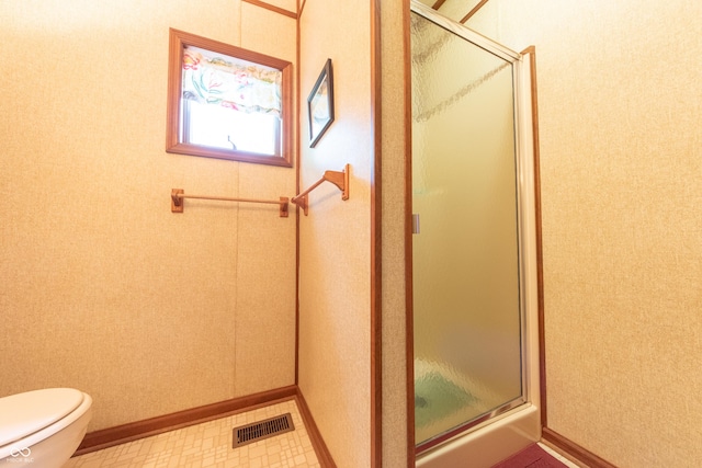 5821 Bittersweet Rd, Morgantown, IN 46160 - bathroom with a shower stall, toilet, baseboards, and tile patterned floors
