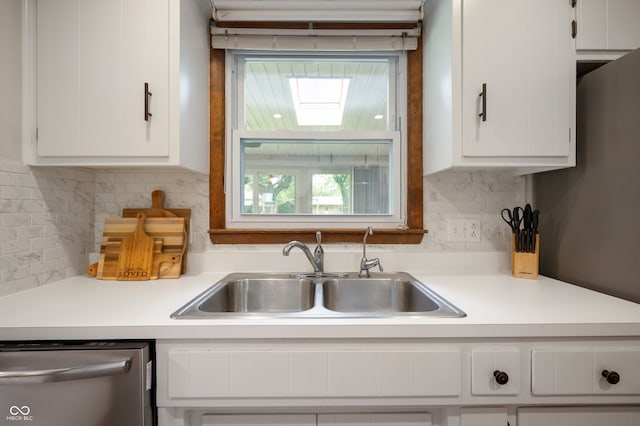 1495 E 240 N, Anderson, IN 46012 - kitchen featuring stainless steel dishwasher, a sink, white cabinetry, light countertops, and decorative backsplash