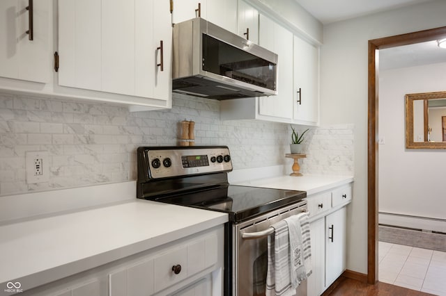 1495 E 240 N, Anderson, IN 46012 - kitchen with stainless steel appliances, a baseboard heating unit, light countertops, and white cabinetry