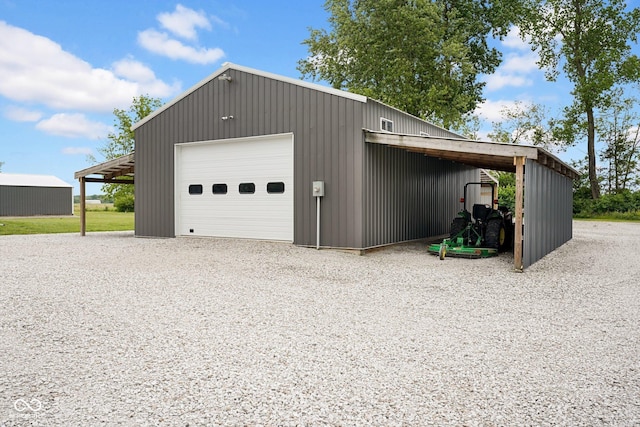 1295 Colonial Dr, Seymour, IN 47274 - garage featuring a garage and gravel driveway
