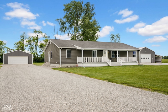 1295 Colonial Dr, Seymour, IN 47274 - single story home featuring a porch, a detached garage, an outdoor structure, and a front lawn