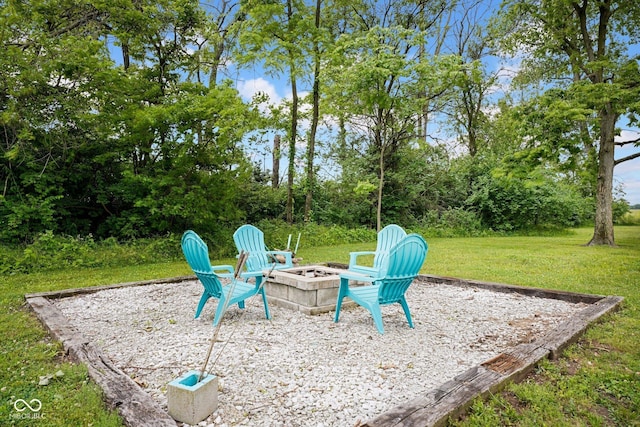 1295 Colonial Dr, Seymour, IN 47274 - view of patio featuring an outdoor fire pit and view of scattered trees