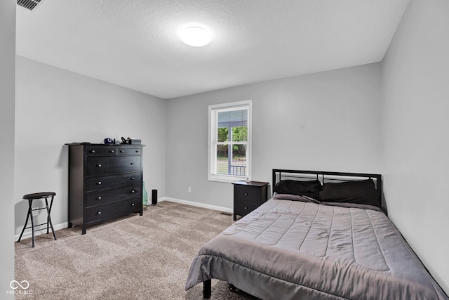 1295 Colonial Dr, Seymour, IN 47274 - carpeted bedroom with a textured ceiling and baseboards
