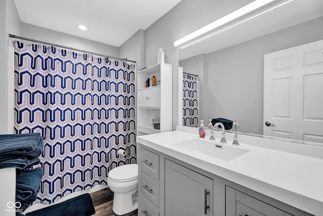 1295 Colonial Dr, Seymour, IN 47274 - bathroom featuring vanity, wood finished floors, curtained shower, and recessed lighting