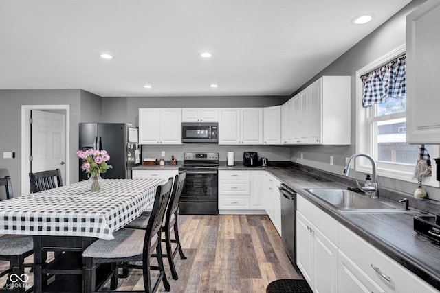 1295 Colonial Dr, Seymour, IN 47274 - kitchen featuring stainless steel appliances, dark wood finished floors, white cabinets, recessed lighting, and dark countertops