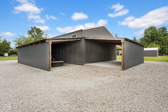 1295 Colonial Dr, Seymour, IN 47274 - view of home's exterior with an outbuilding, a carport, and gravel driveway