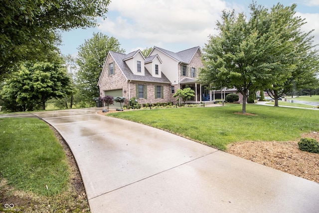 917 E Mill Creek Rd S, Greensburg, IN 47240 - view of front of house with brick siding, concrete driveway, an attached garage, and a front yard