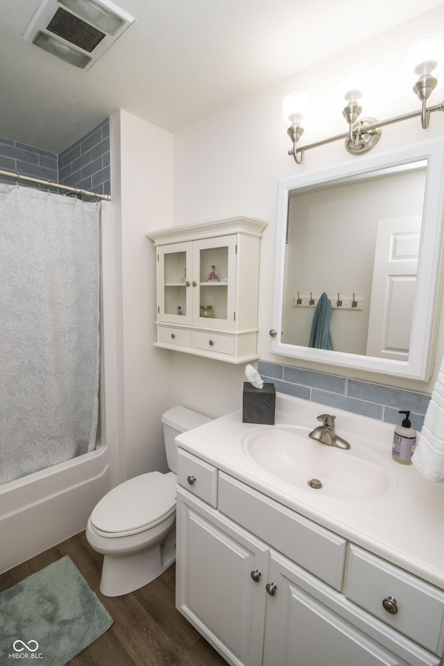 917 E Mill Creek Rd S, Greensburg, IN 47240 - full bath with vanity, toilet, wood finished floors, shower / tub combo with curtain, and decorative backsplash