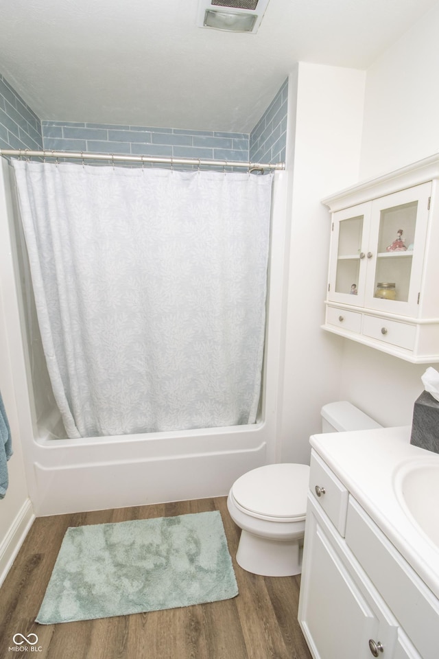 917 E Mill Creek Rd S, Greensburg, IN 47240 - bathroom featuring toilet, vanity, wood finished floors, and shower / tub combo